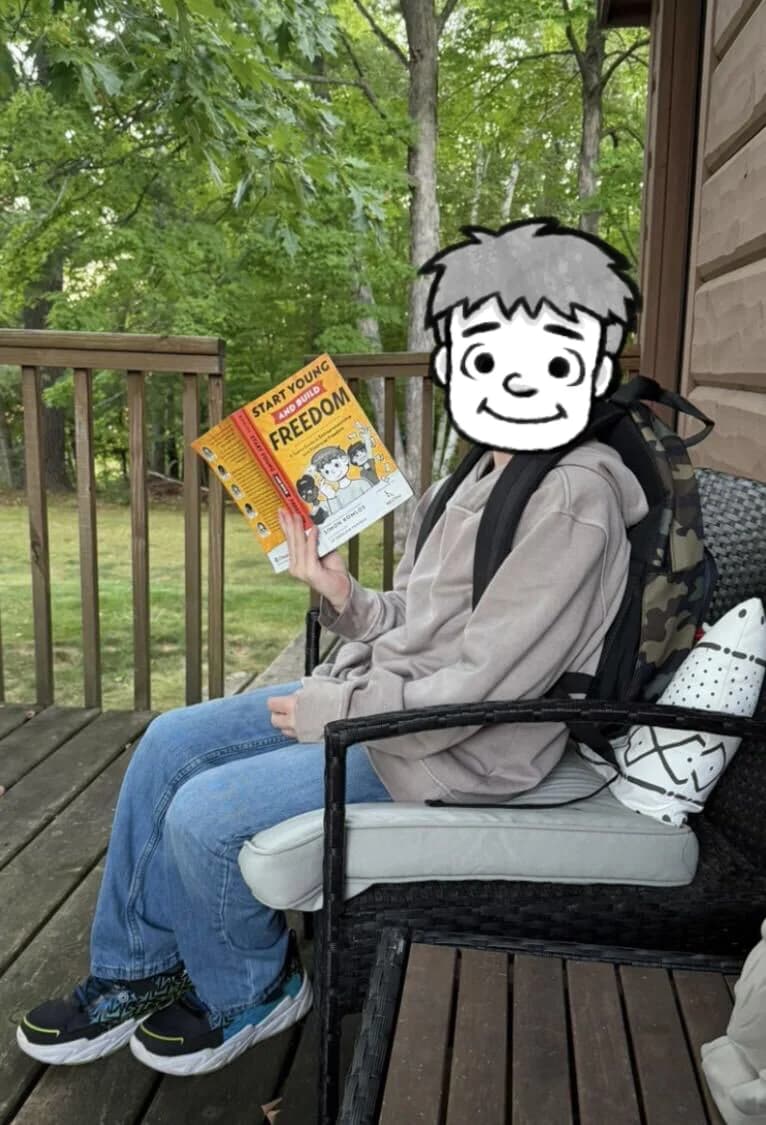 Young reader holding Start Young and Build Freedom